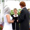 wedding held on the lawn of a horse ranch in McMinville, Oregon. Beautiful summer blooms, wedding trellis, outdoor wedding. The Radiant Touch Wedding performed by Beverly Mason. Oregon wedding officiant. Photography by Radiant Touch